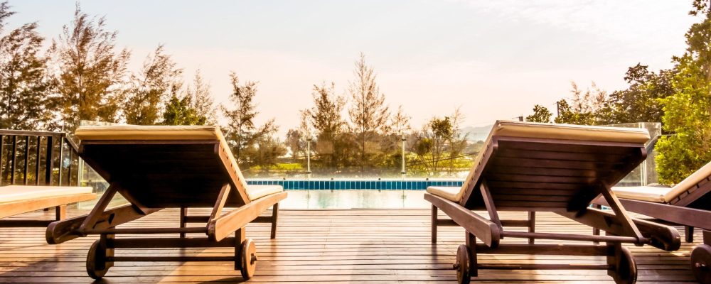 Empty chair and swimming pool at hotel resort - Vintage Filter